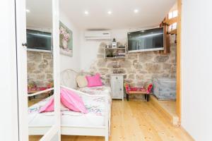 a living room with a couch and a tv at House - Apartment Dama in Split