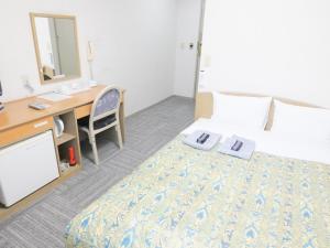 Postel nebo postele na pokoji v ubytování Urban Hotel Sanko