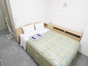 Postel nebo postele na pokoji v ubytování Urban Hotel Sanko