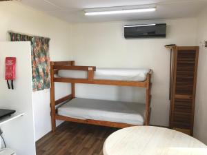 a room with two bunk beds and a table at Lake Albert Caravan Park in Meningie