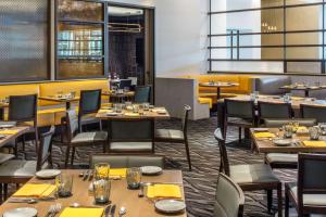 a restaurant with tables and chairs and yellow walls at Hyatt Regency McCormick Place in Chicago