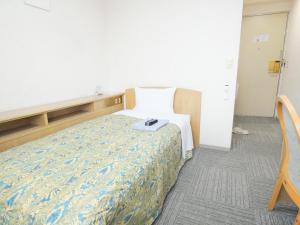 Postel nebo postele na pokoji v ubytování Urban Hotel Sanko