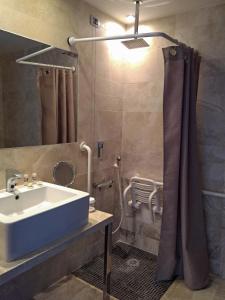a bathroom with a shower, sink, and tub at Hotel Delle Terme Di Venturina in Venturina Terme