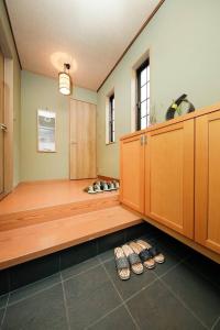 a room with a row of shoes on the floor at Ryokan ASAKUSA-chaka- in Tokyo