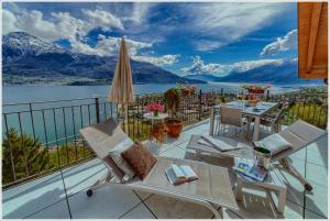 a balcony with a view of the water and mountains at Villa Aquarius - Larihome A08 in Vercana