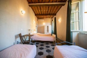 A bed or beds in a room at Ostello Palazzo Nizza