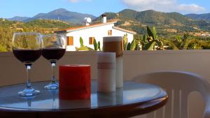 two glasses of wine on a table with a view at Astrofegia Apartments Near The Sea in Ayia Marina