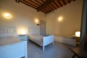 a hotel room with a bed and two lamps at Ostello Palazzo Nizza in Massa