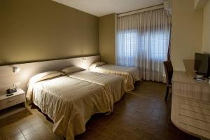 Rúm í herbergi á Hotel Scacciapensieri