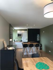 a kitchen and dining room with a table and chairs at La Maison du Grand Four in Mercurey