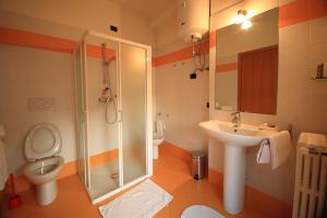 a bathroom with a toilet and a sink and a shower at ARCOBALENO AFFITTACAMERE in Verona