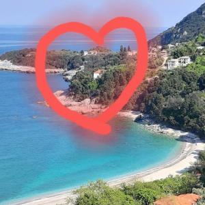 a red heart shape in front of a beach at Katerina Fotopoulos Rooms & Apartments - Papanero com in Agios Ioannis Pelio