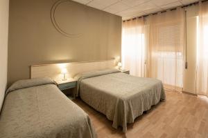 Rúm í herbergi á Hotel Scacciapensieri