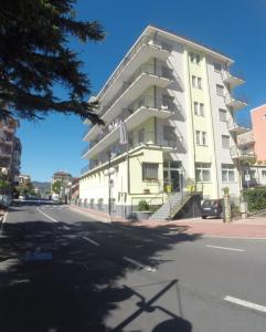 a large white building on the side of a street at Residence San Francisco in Marina di Andora