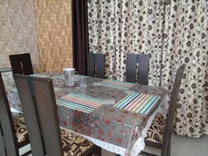 a table with chairs and a table with a table cloth at Vacation Paradise in Bhowāli