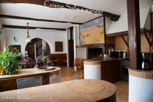 a kitchen with a table and a counter top at La chambre la Tricherie in Crastes