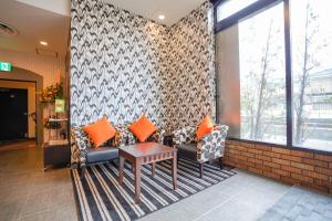 a lobby with couches and a table in a building at APA Hotel Hachioji Eki Nishi in Hachioji