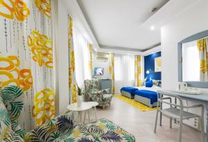 a hotel room with a bedroom and a bed at Relax Comfort Suites Hotel in Bucharest