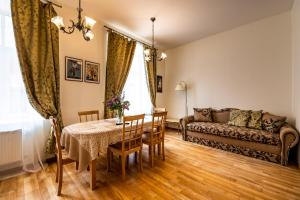 a living room with a table and a couch at Concert Hall in Liepāja