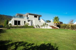 a house with a large lawn in front of it at Wilkes Way Villa in Picton