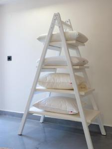 a white shelf with pillows on it at Eva Mare Hotel & Suites - Adults only in Agia Pelagia