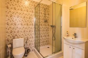 a bathroom with a shower and a toilet and a sink at Veranda Suite in Liepāja +37 photos