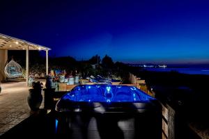 a blue tub sitting next to a beach at night at Corali House in Stavros