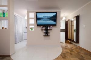 a flat screen tv on a wall in a hallway at Apartament Deluxe Arcon in Siemianowice Śląskie +13 photos