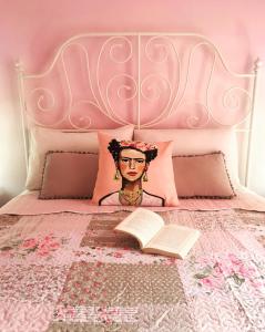 a bed with a headboard and a book on it at Villa Loukia in Corfu