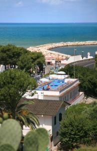 a view of a building with a pool and the ocean at B&B Ala Marina in Peschici