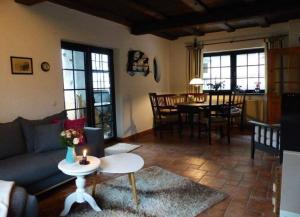 a living room with a couch and a table at Darßer Strandgut - Haus Butzek in Ahrenshoop