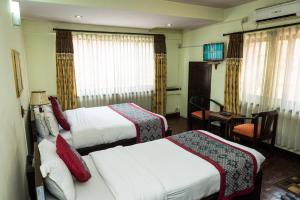 Kama o mga kama sa kuwarto sa Hotel Encounter Nepal & Spa