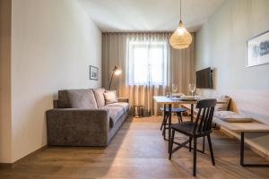 a living room with a couch and a table at Landhaus Lina in Caldaro