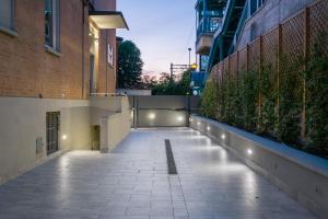 an empty sidewalk in a city at night at Aparthotel Sant'Orsola in Bologna