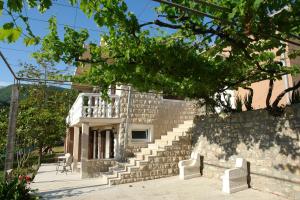 a stone building with stairs and a balcony at R&B Apartments in Budva