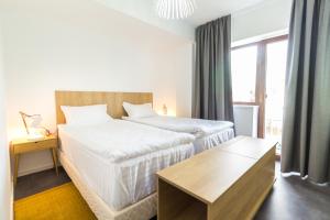 a hotel room with two beds and a table at Horeum Boutique Hotel in Sibiu