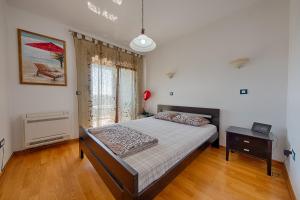 a bedroom with a large bed and a window at Beki Apartment in Bar