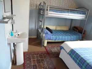 a bathroom with two bunk beds and a sink at Galway Guest House in Weymouth