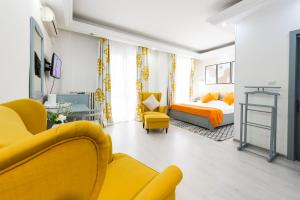 
a living room filled with furniture and a couch at Relax Comfort Suites Hotel in Bucharest
