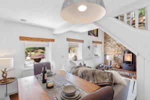 a living room with a couch and a table at Harewood Cottage Peak District in Leek