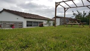 a picnic table in a yard next to a house at Our relaxing holiday home in Mosteiros