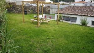 a picnic table in the yard of a house at Our relaxing holiday home in Mosteiros