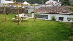 a picnic table in the yard of a house at Our relaxing holiday home in Mosteiros