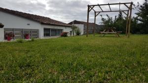 a picnic table in a yard next to a house at Our relaxing holiday home in Mosteiros