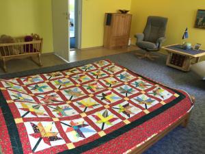 a quilt on top of a bed in a room at Torgu Royal Guesthouse in Iide +119 photos