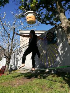 a person jumping in the air with a frisbee at Meiga Backpackers Hostel in Santiago de Compostela