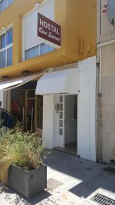 an entrance to a building with a sign that reads hospital can service at Hostal Can Joanet in Cambrils