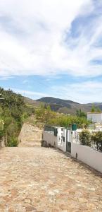 a dirt road with a building on a hill at Casa Rodrigues in Pinhão
