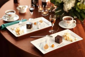 a table with two plates of food and glasses of wine at The Mansion on Delaware Avenue in Buffalo
