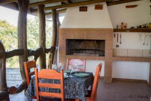 a dining room with a table and a fireplace at Die Oog in Richards Bay